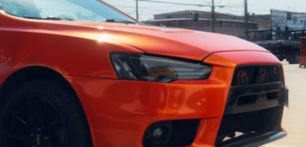 A striking red car parked at a sunny Brazilian gas station in São Paulo, Brazil.